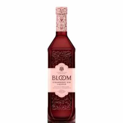 A bottle of Bloom Strawberry Gin Liqueur, surrounded by fresh strawberries and ice cubes.