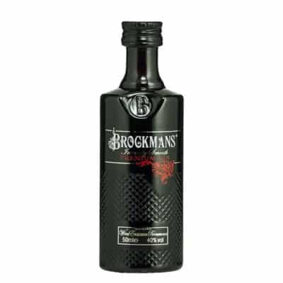 A miniature bottle of Brockmans Gin with a black bottle and a silver cap.