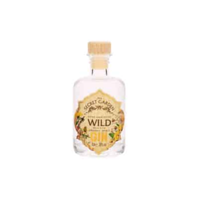 A miniature bottle of Secret Garden Wild Gin with a wooden cap.